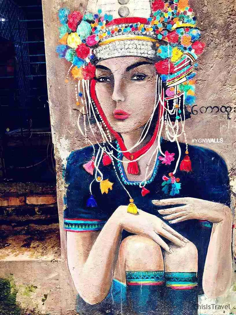 Mural de una mujer birmana con tocado de cuentas de colores